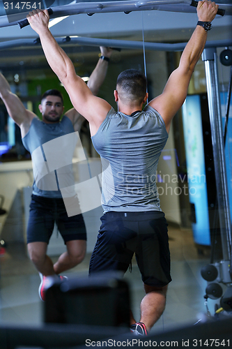 Image of handsome man exercising at the gym