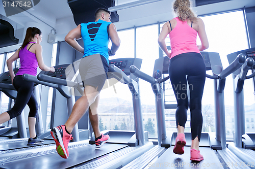 Image of woman exercising on treadmill in gym