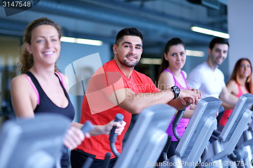 Image of Group of people running on treadmills
