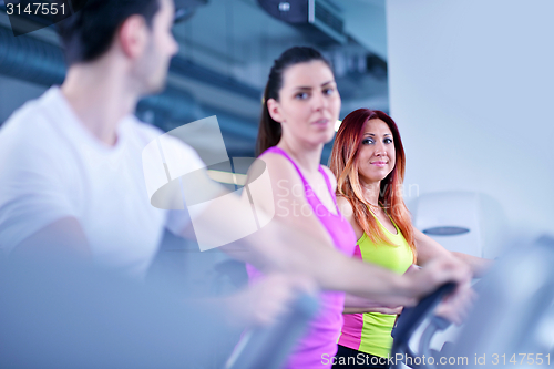 Image of Group of people running on treadmills