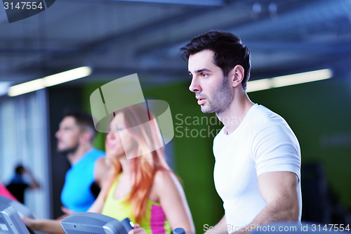 Image of Group of people running on treadmills