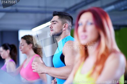 Image of Group of people running on treadmills