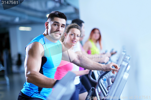 Image of Group of people running on treadmills