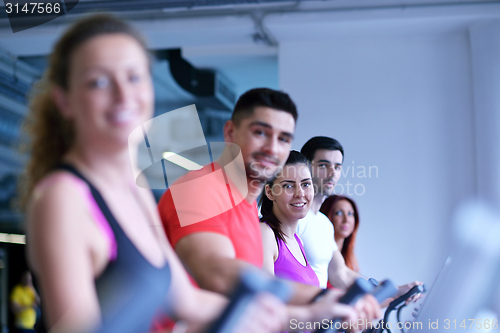 Image of Group of people running on treadmills