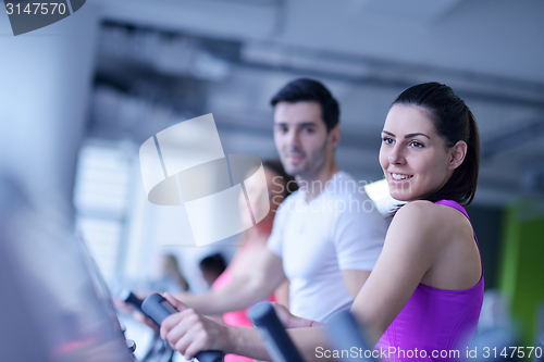 Image of Group of people running on treadmills