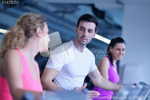 Image of Group of people running on treadmills