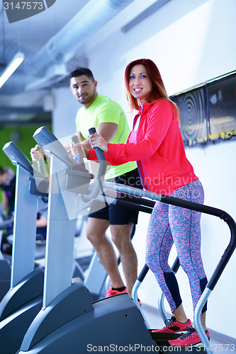 Image of Group of people running on treadmills