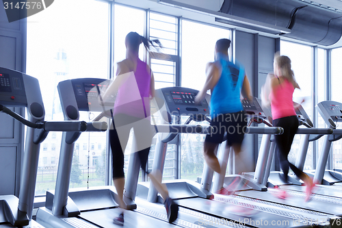 Image of Group of people running on treadmills