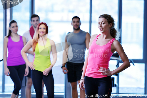 Image of Group of people exercising at the gym