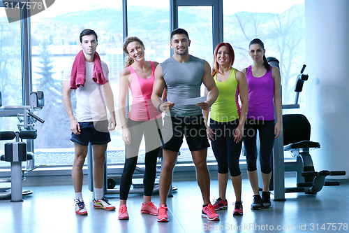 Image of Group of people exercising at the gym