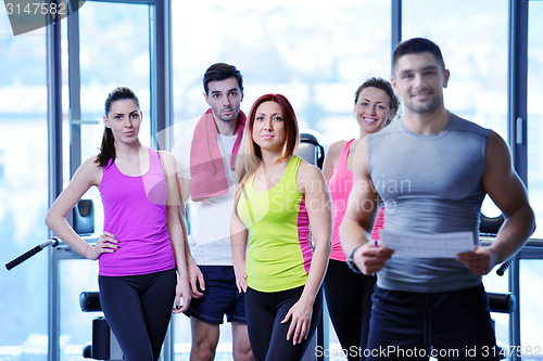 Image of Group of people exercising at the gym