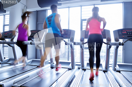 Image of Group of people running on treadmills