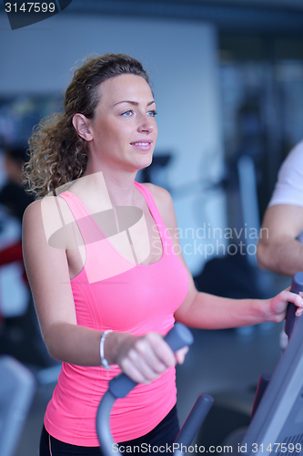 Image of woman exercising on treadmill in gym
