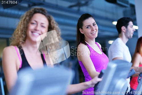 Image of Group of people running on treadmills