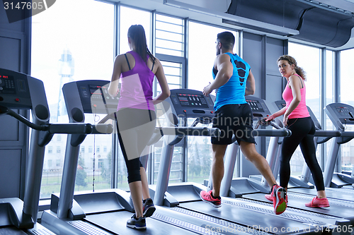 Image of Group of people running on treadmills