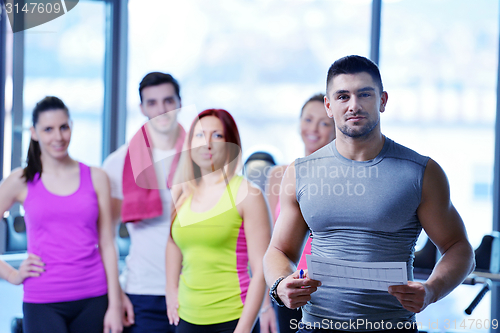 Image of Group of people exercising at the gym