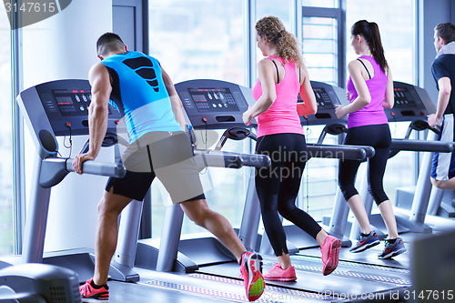 Image of Group of people running on treadmills