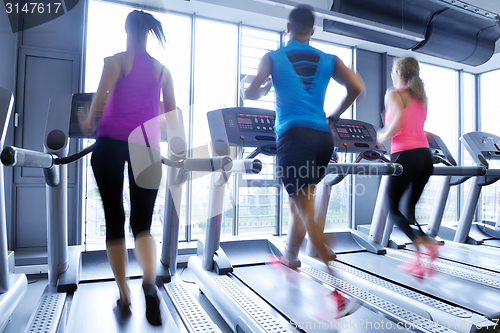 Image of Group of people running on treadmills