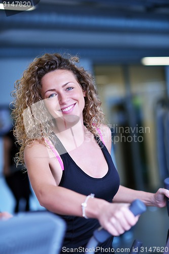 Image of woman exercising on treadmill in gym