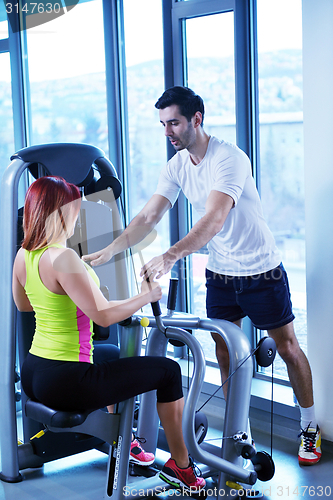 Image of woman exercising with her personal trainer