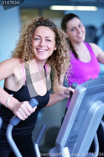 Image of woman exercising on treadmill in gym