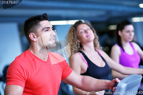 Image of Group of people running on treadmills