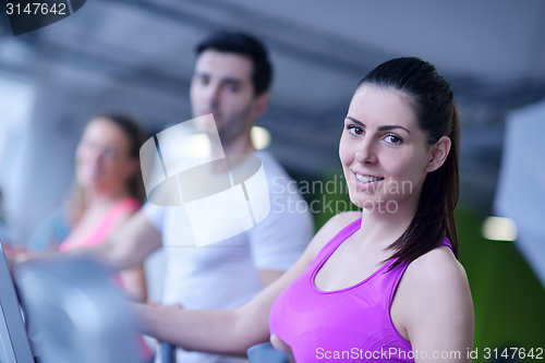 Image of Group of people running on treadmills