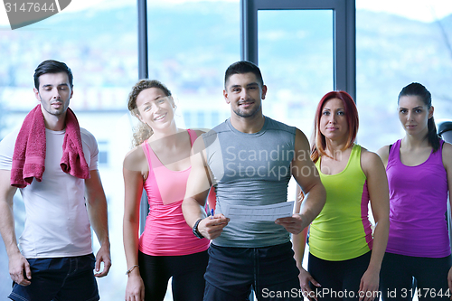 Image of Group of people exercising at the gym