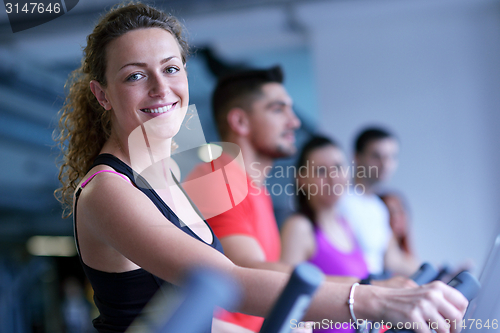 Image of Group of people running on treadmills