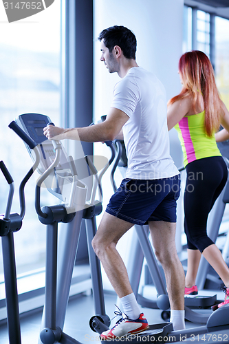 Image of Group of people running on treadmills