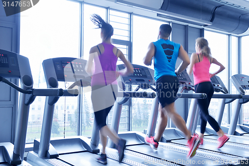 Image of Group of people running on treadmills