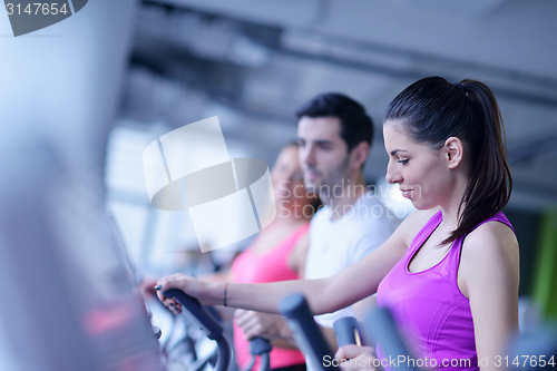 Image of Group of people running on treadmills