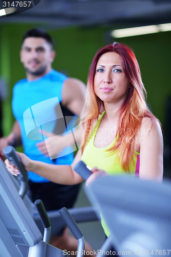 Image of Group of people running on treadmills