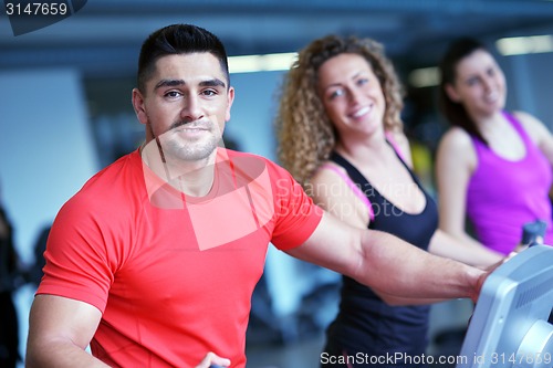 Image of Group of people running on treadmills
