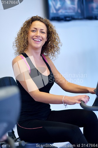 Image of woman exercising on treadmill in gym
