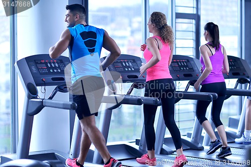 Image of Group of people running on treadmills