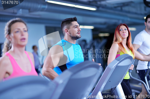 Image of Group of people running on treadmills