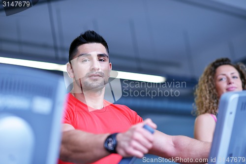 Image of Group of people running on treadmills