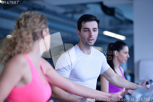 Image of Group of people running on treadmills