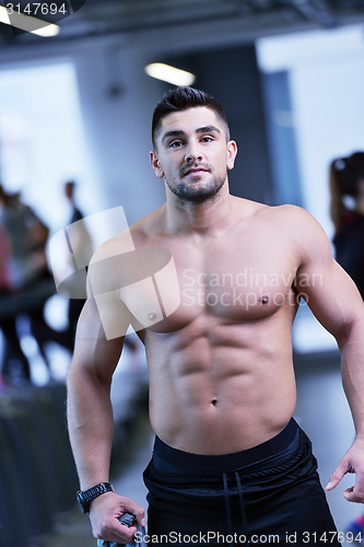 Image of handsome man exercising at the gym