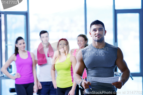 Image of Group of people exercising at the gym