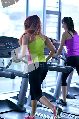 Image of woman exercising on treadmill in gym