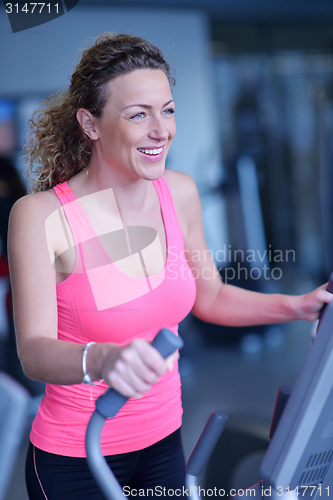 Image of woman exercising on treadmill in gym