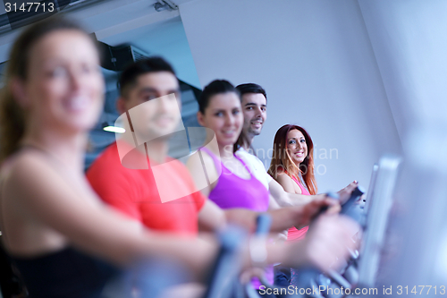 Image of Group of people running on treadmills