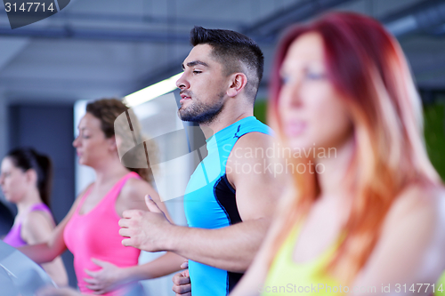 Image of Group of people running on treadmills