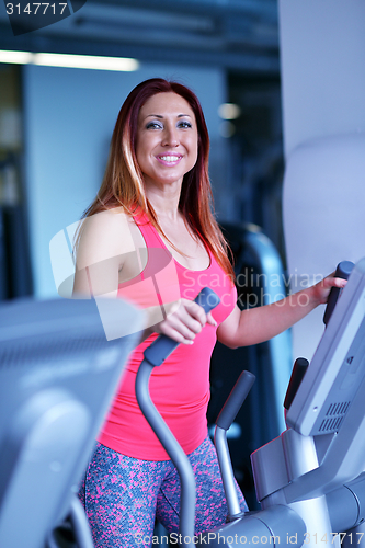 Image of woman exercising on treadmill in gym