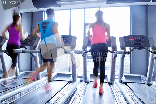 Image of Group of people running on treadmills