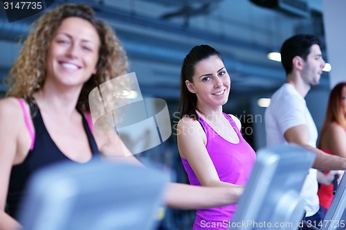 Image of Group of people running on treadmills