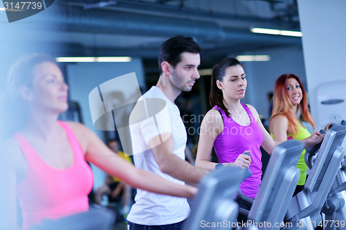 Image of Group of people running on treadmills