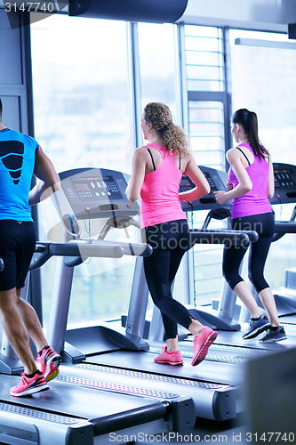 Image of Group of people running on treadmills